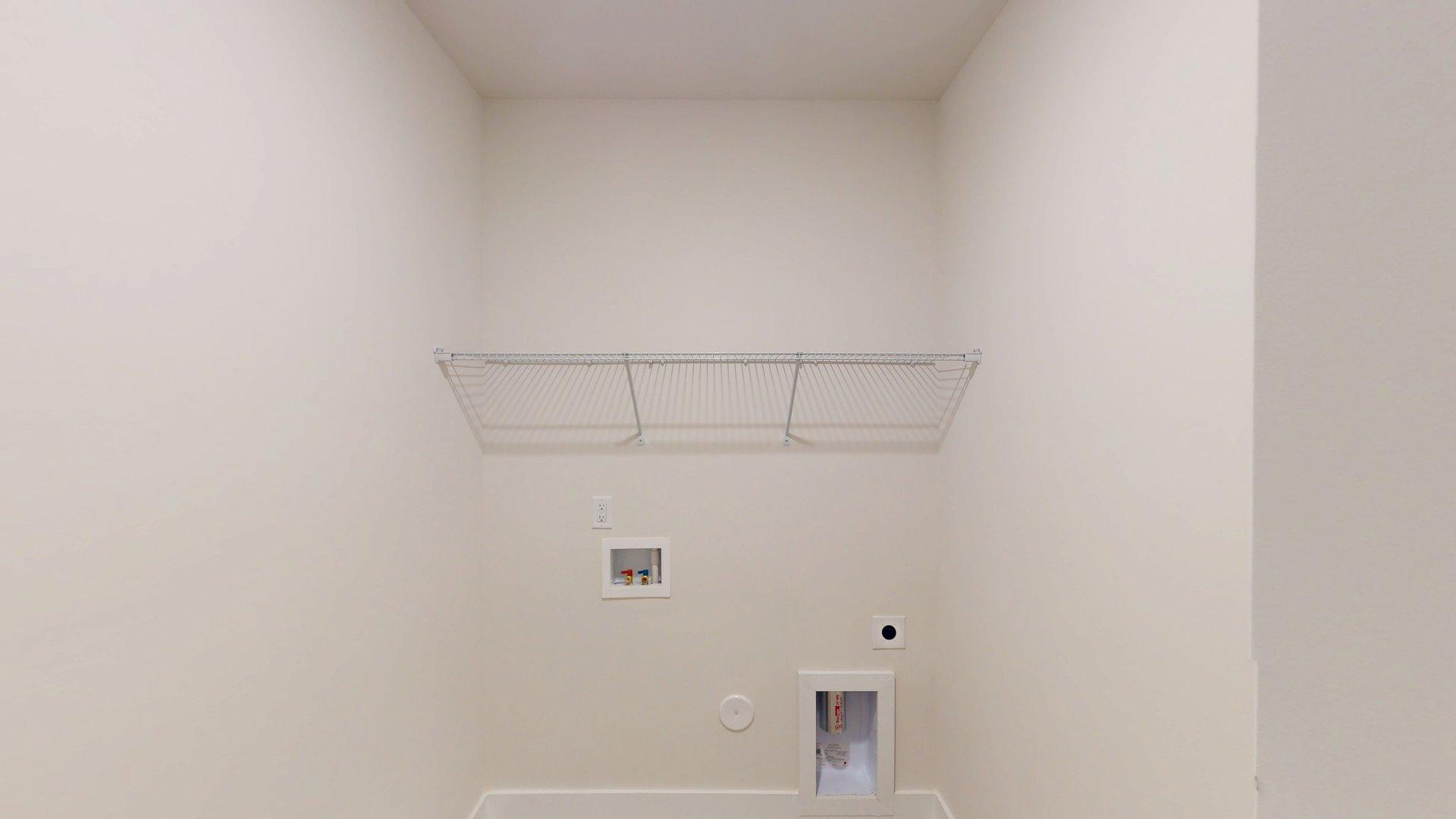 Laundry room with above machine racks