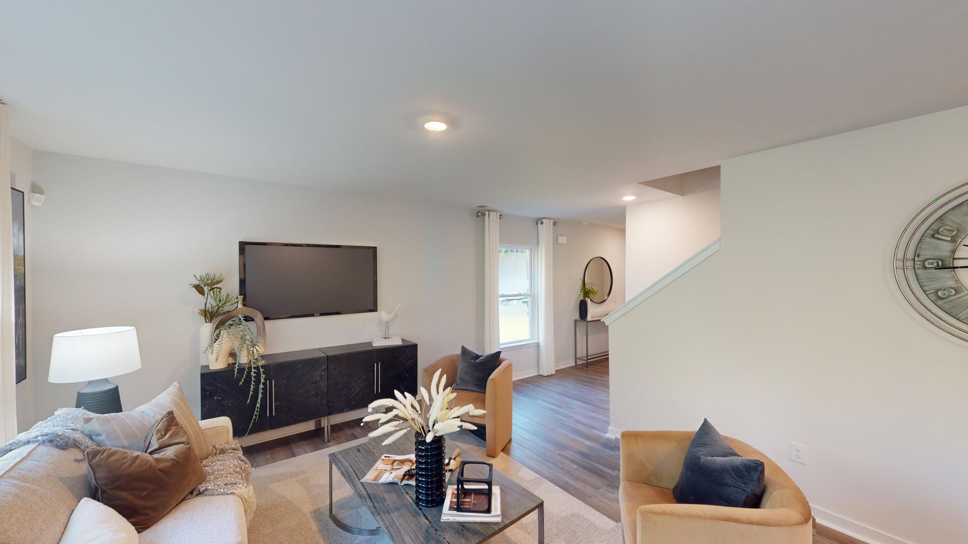 Open living room with 3 large windows and electric fireplace