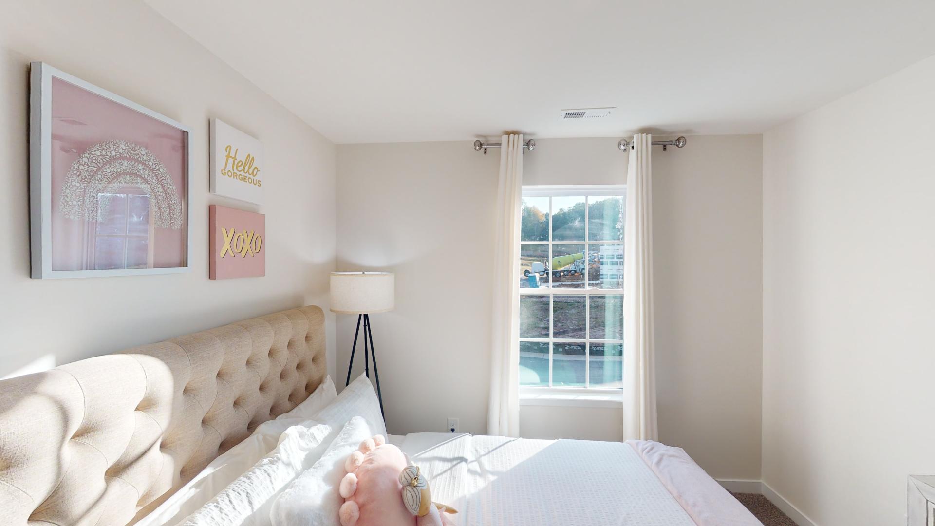 Carpeted bedroom with small window