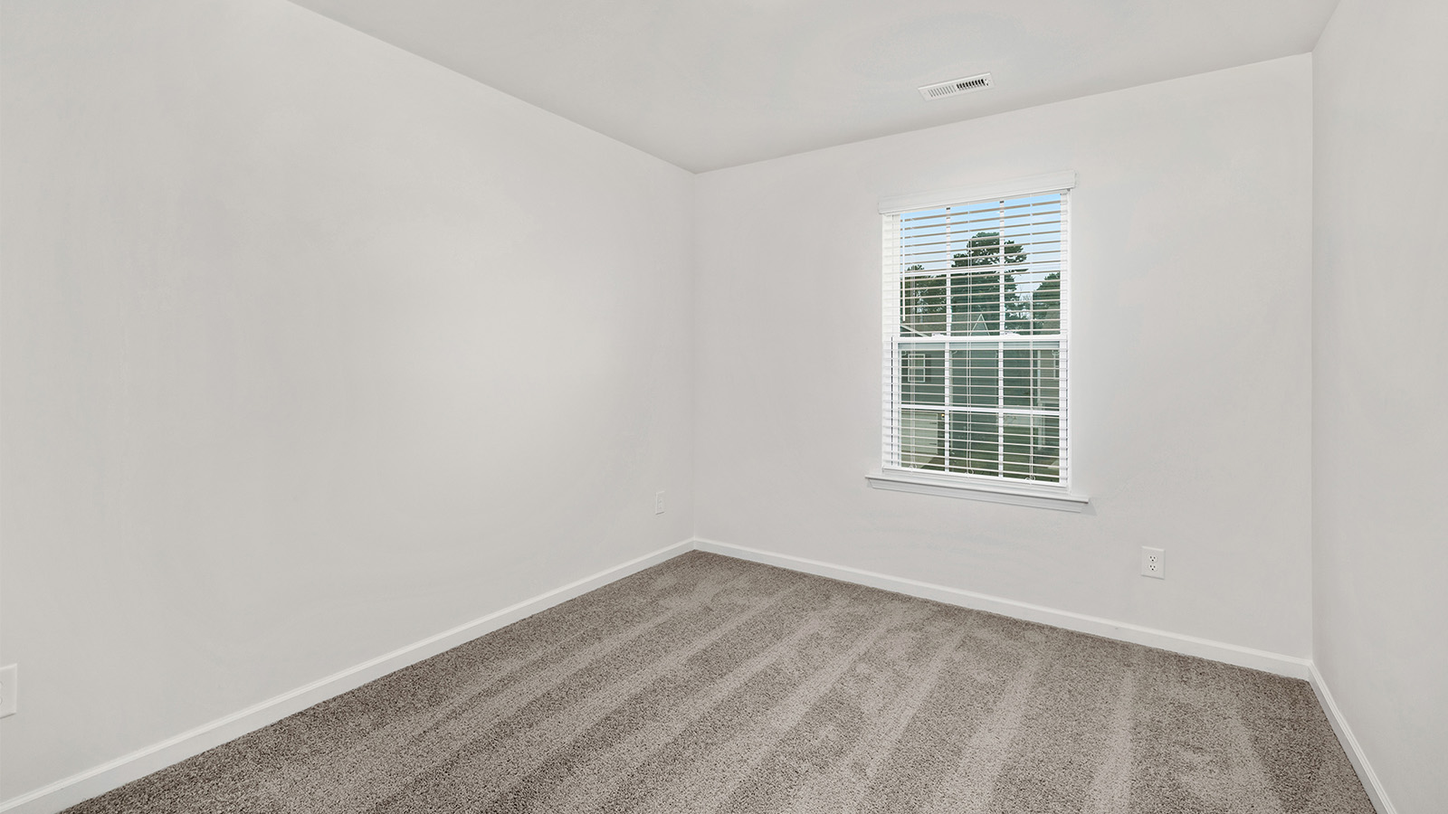 Carpeted bedroom with window