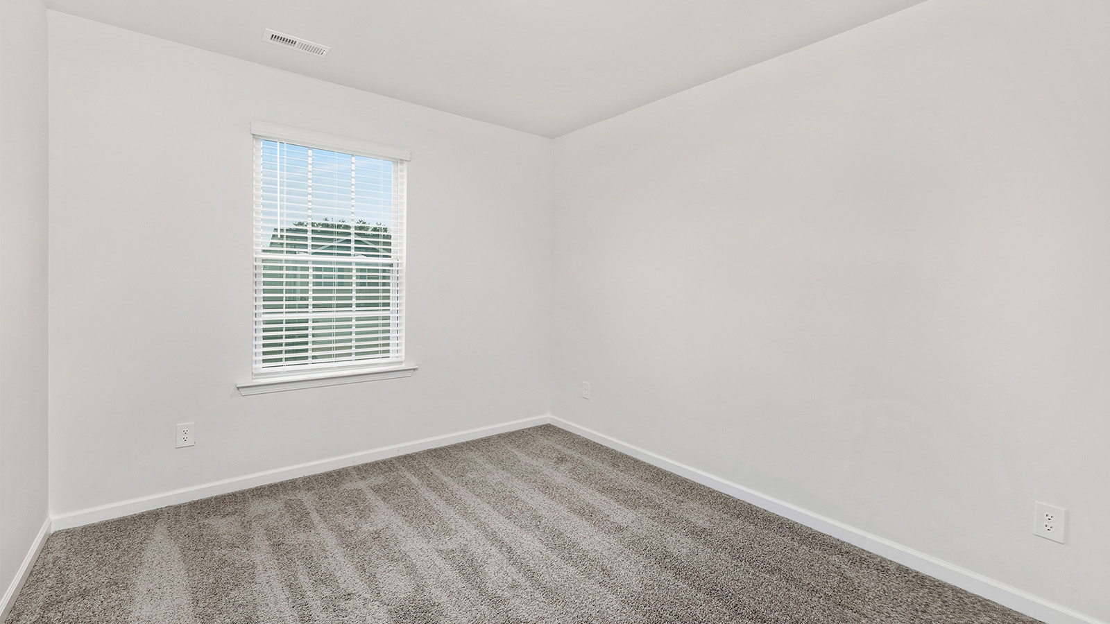 Carpeted bedroom with window