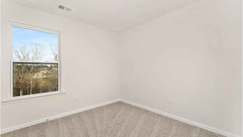 Carpeted bedroom with small window