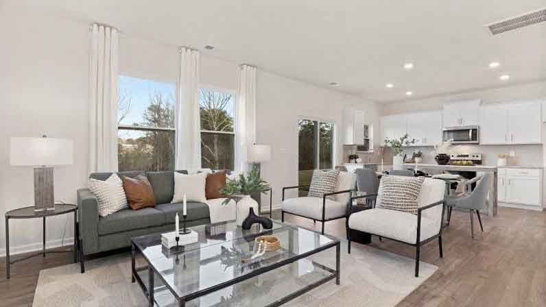 Open living room with 3 large windows and electric fireplace
