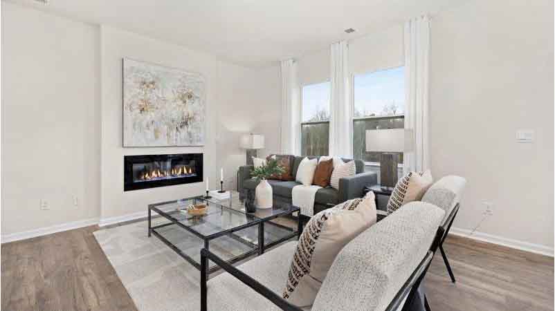 Open living room with 3 large windows and electric fireplace