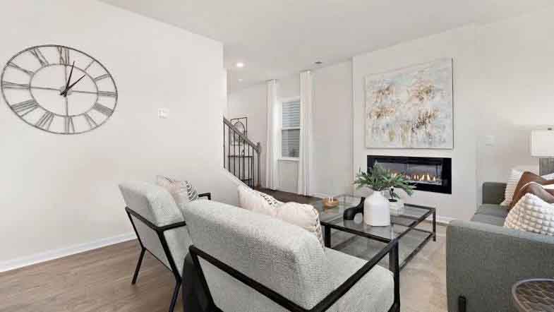 Open living room with 3 large windows and electric fireplace