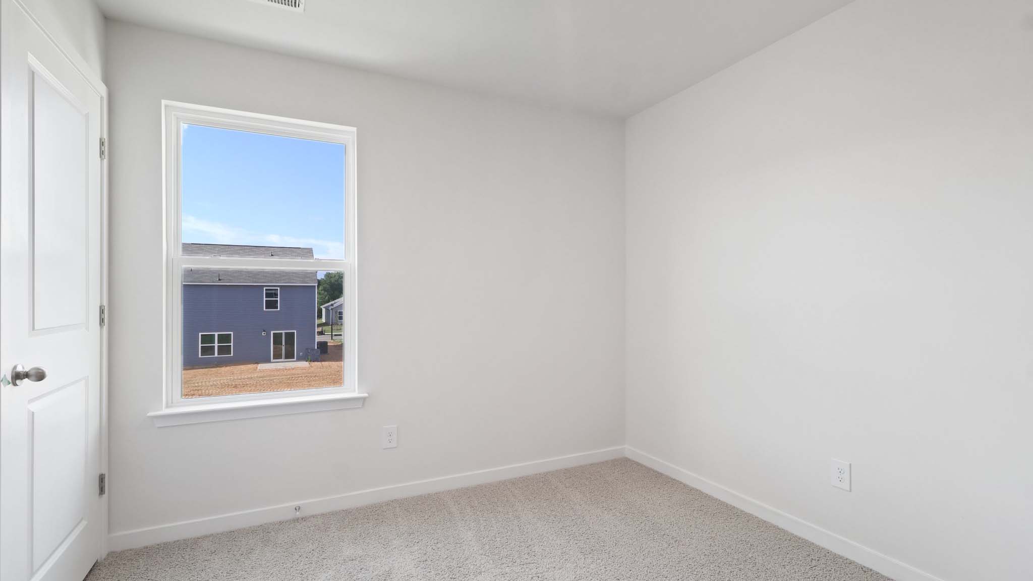 Carpeted bedroom with a window