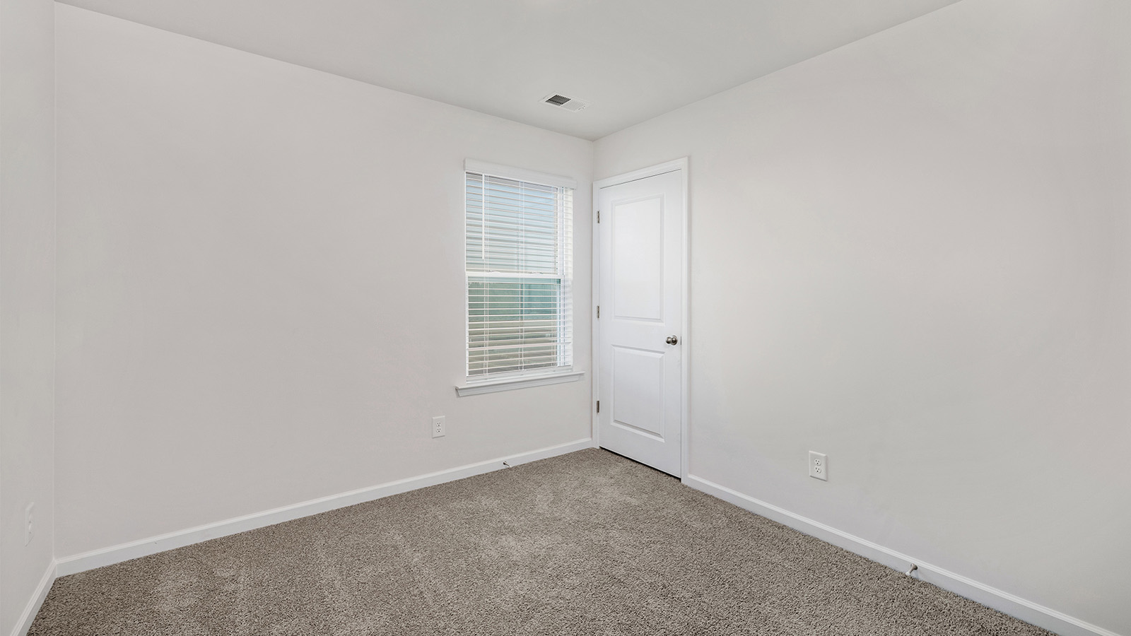 Carpeted bedroom with window