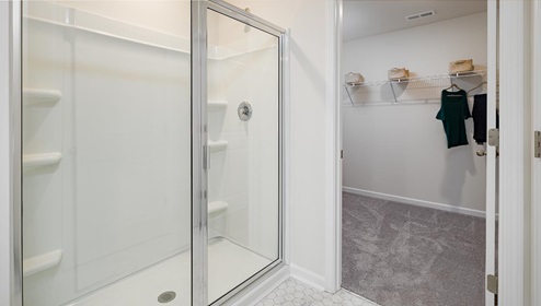Fergus Crossing Penwell Model primary bathroom with glass door shower