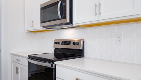 Kitchen and island, white counters and cabinets, white subway tile backsplash