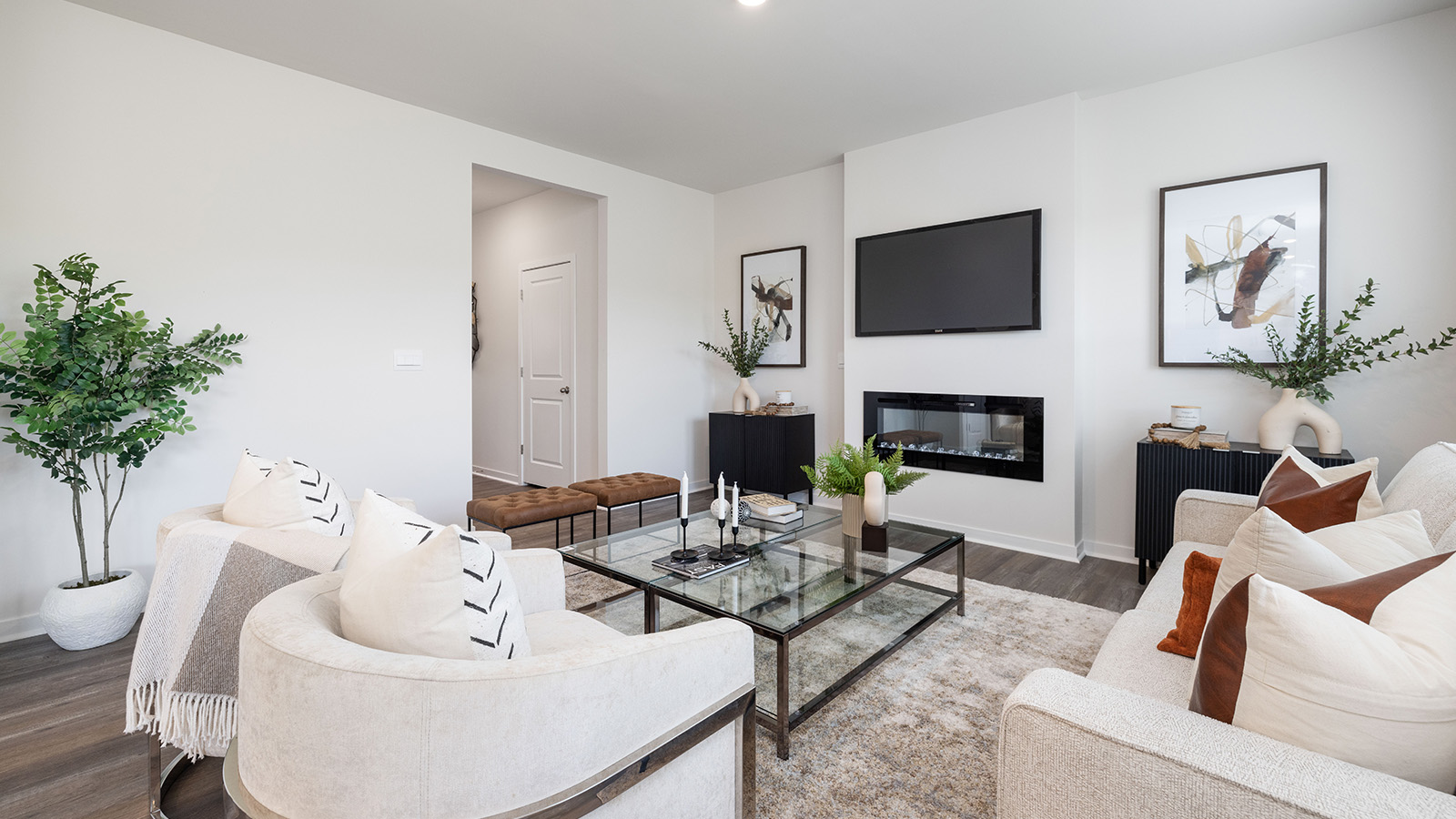 Open living room with 3 large windows and electric fireplace