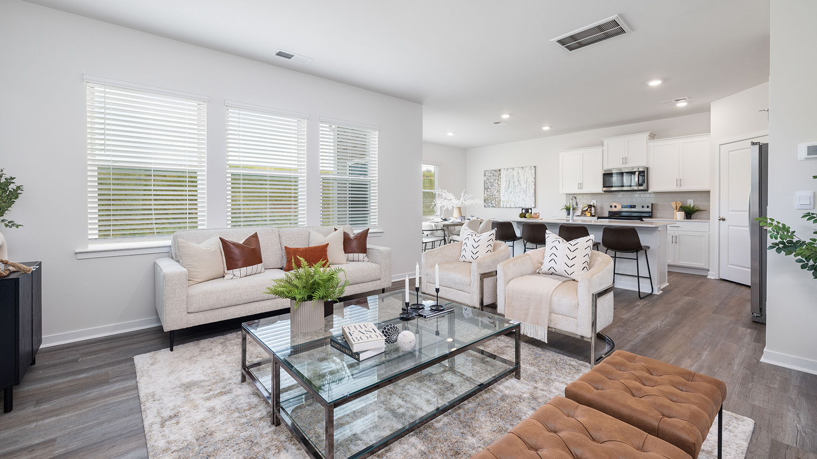 Open living room with 3 large windows and electric fireplace