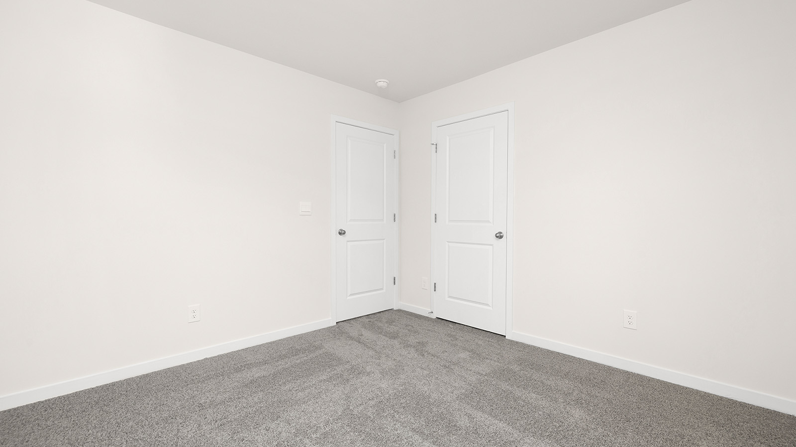 Carpeted bedroom with small window