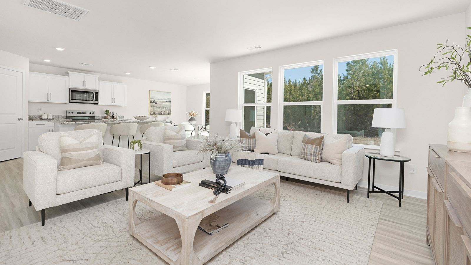 Open living room with 3 large windows and electric fireplace