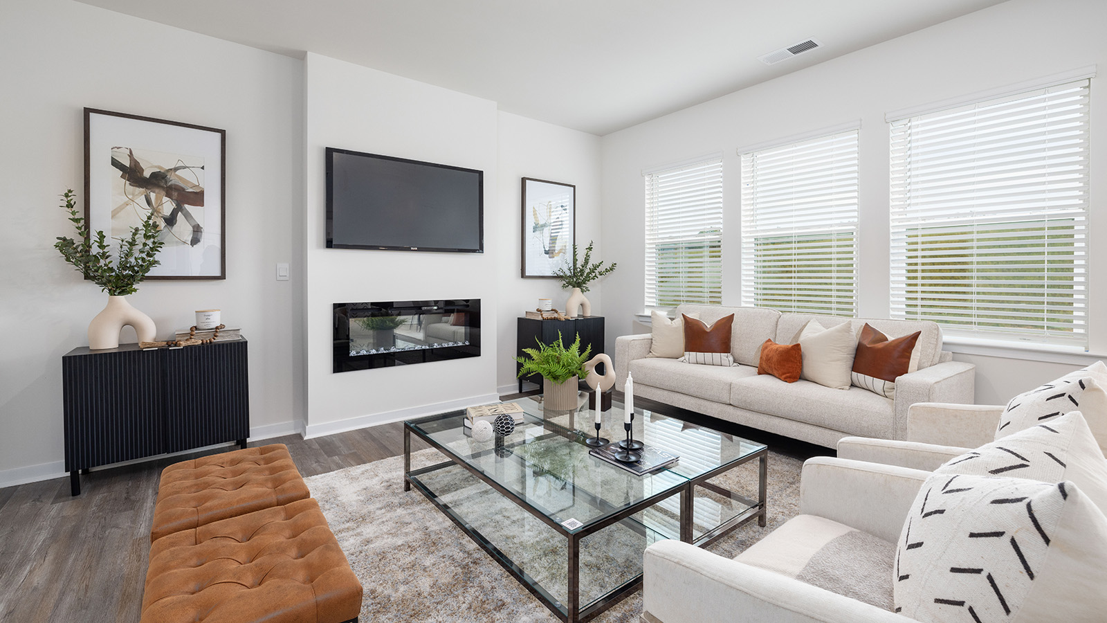 Open living room with 3 large windows and electric fireplace