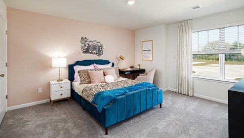 Fergus Crossing Penwell Model carpeted bedroom with large window