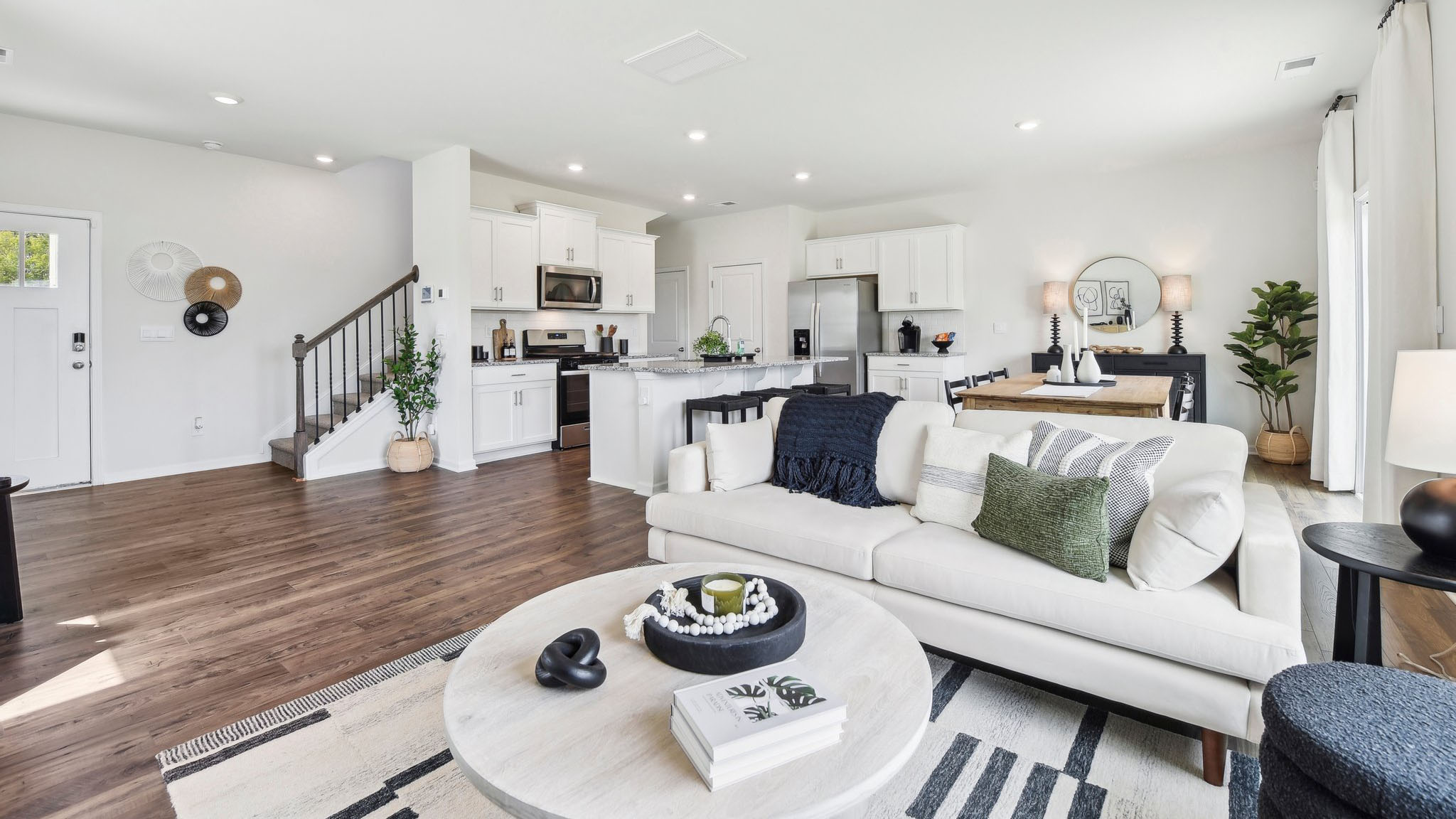 Living room area, with two large windows and wooded floors