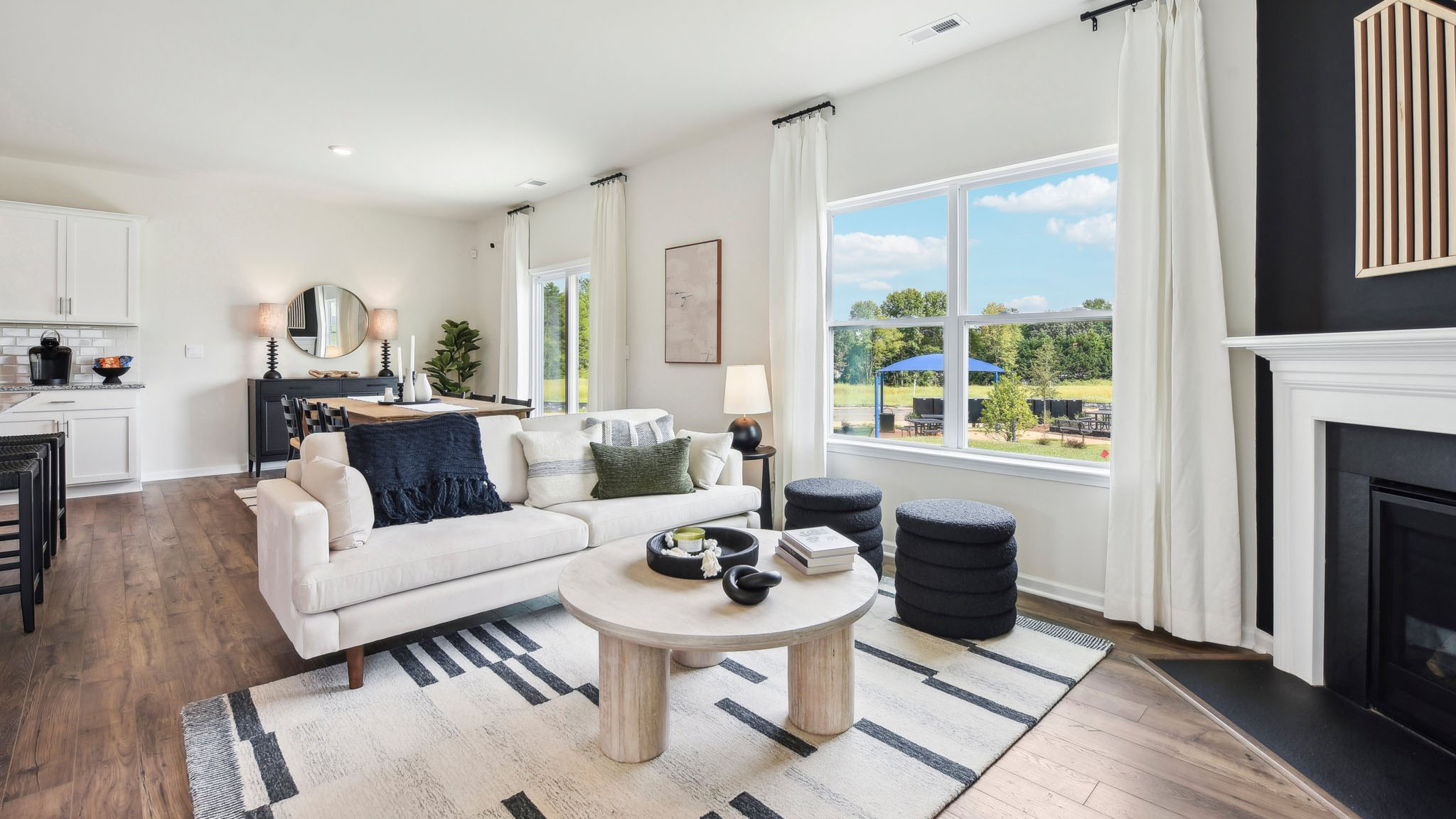 Living room area, with two large windows and wooded floors