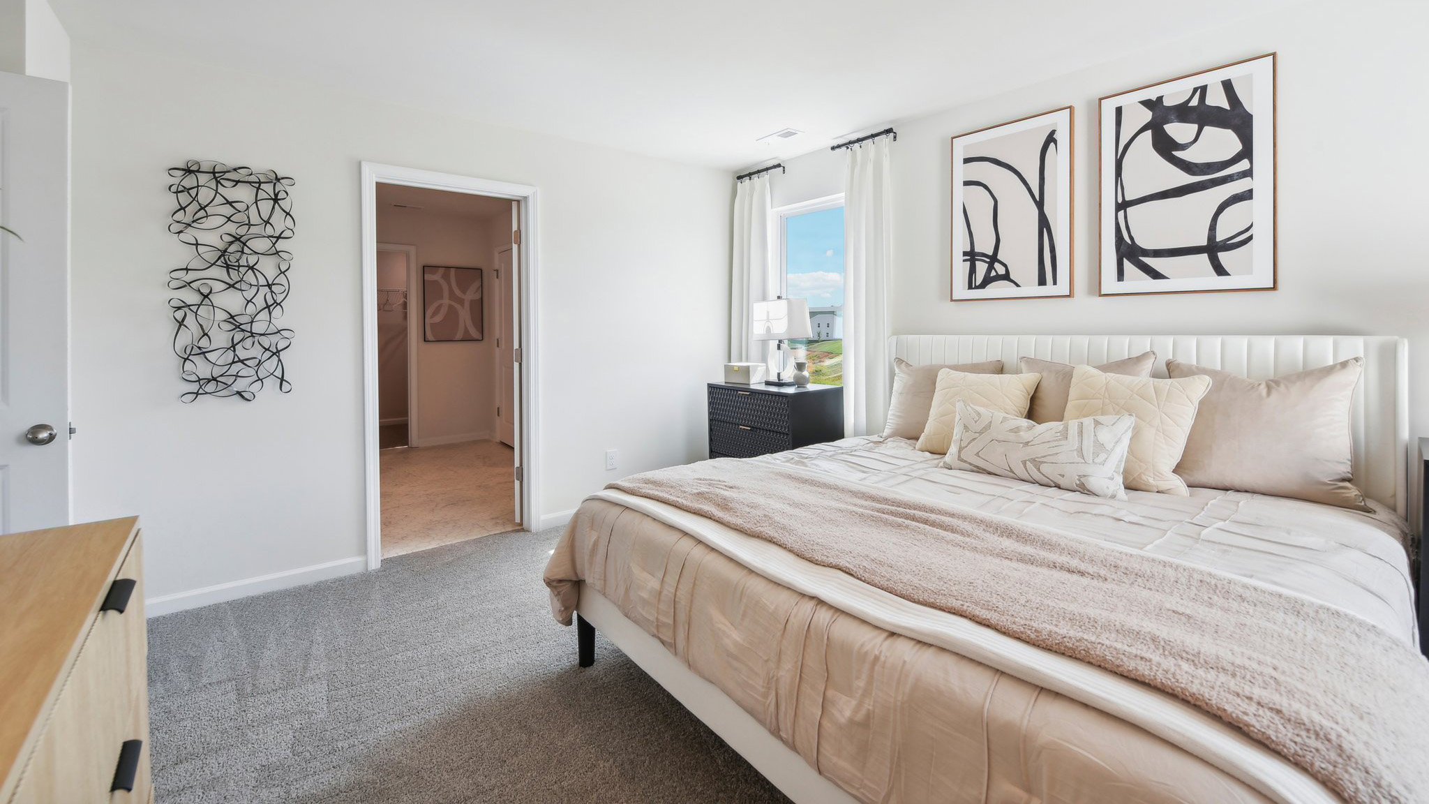 Primary carpeted bedroom with windows