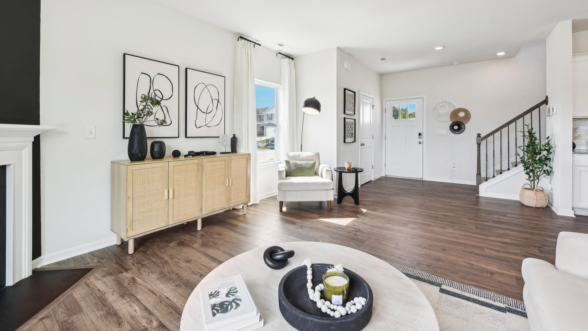 Living room area, with two large windows and wooded floors