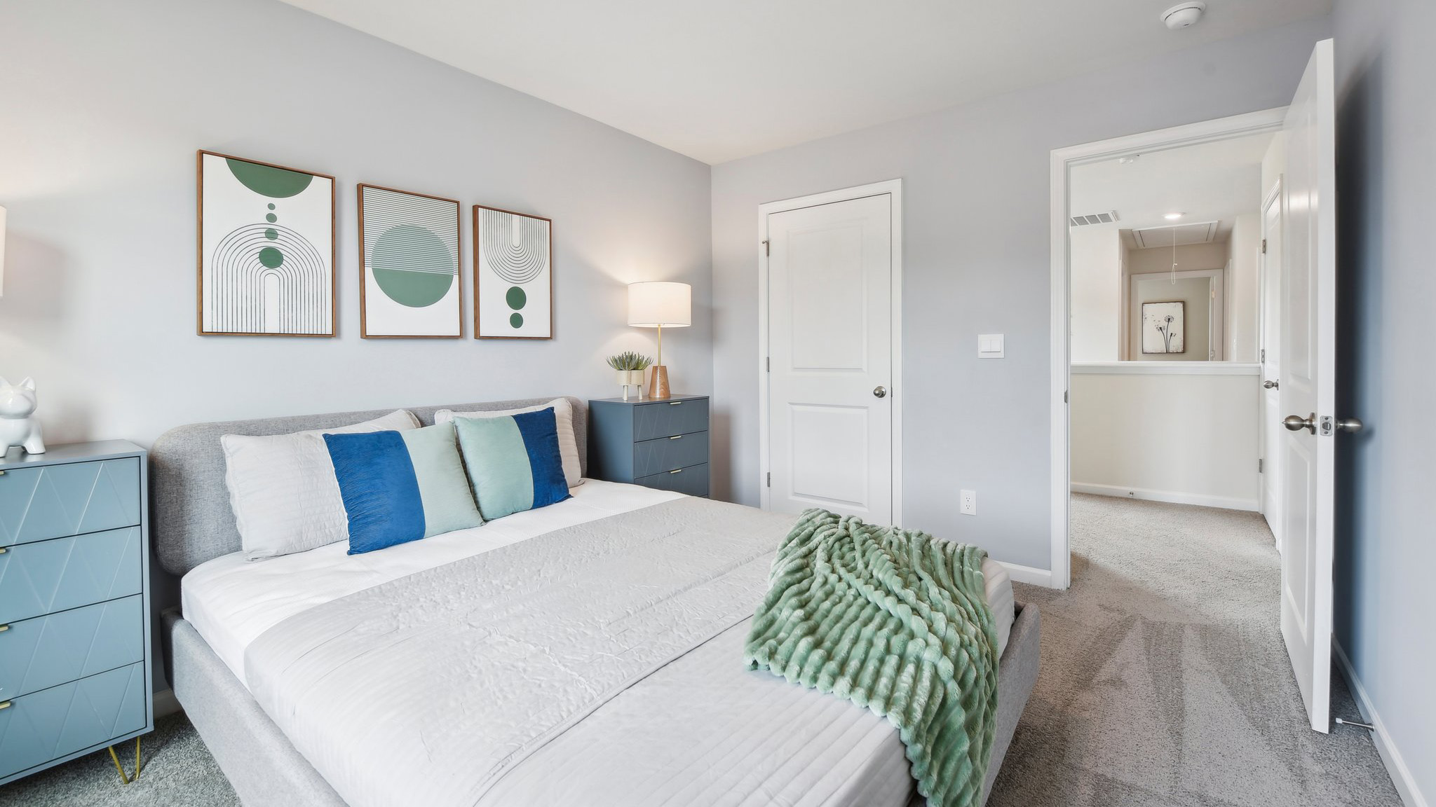Carpeted bedroom with large windows