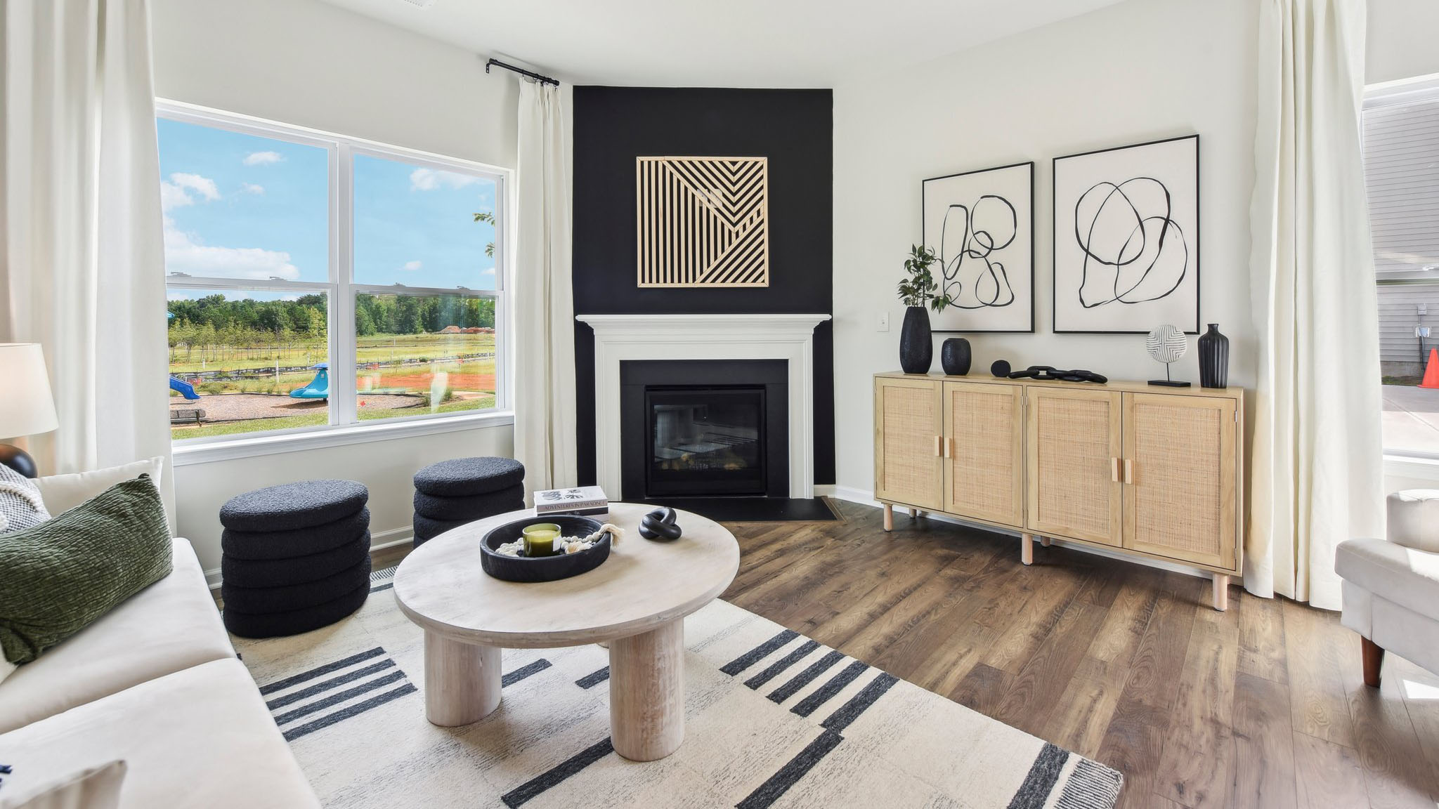 Living room area, with two large windows and wooded floors