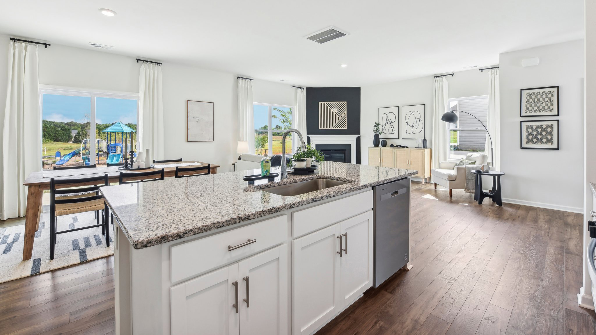 Kitchen and island, white cabinets, wood floors