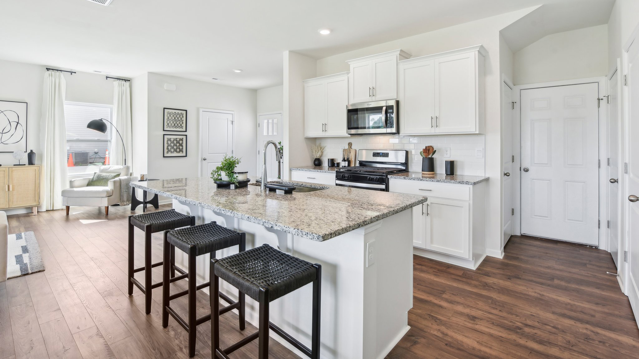Kitchen and island, white cabinets, wood floors