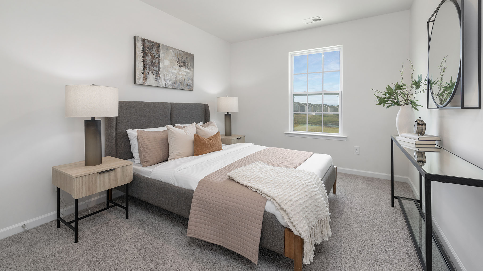 Primary carpeted bedroom with windows