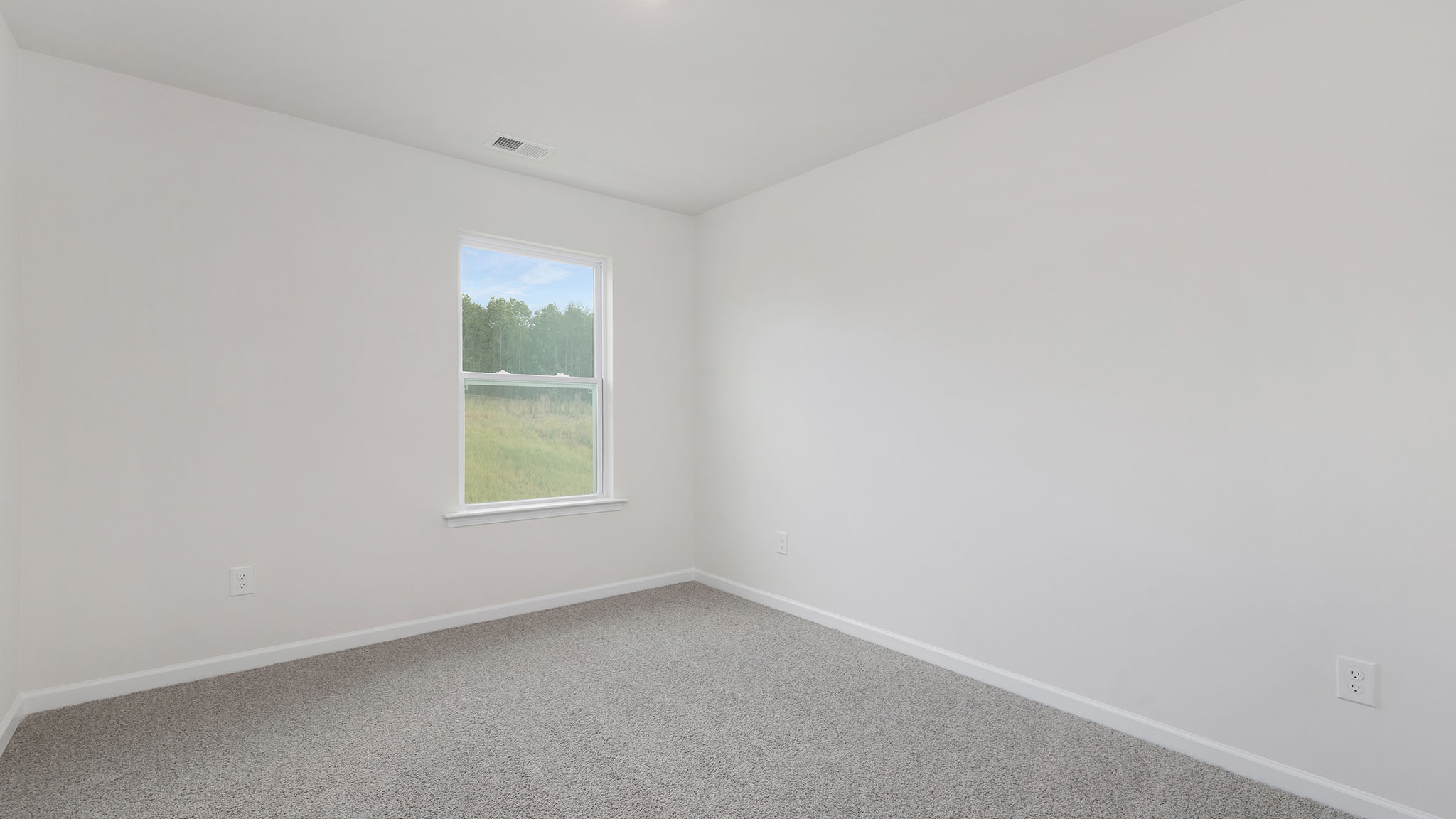 Carpeted bedroom with large windows