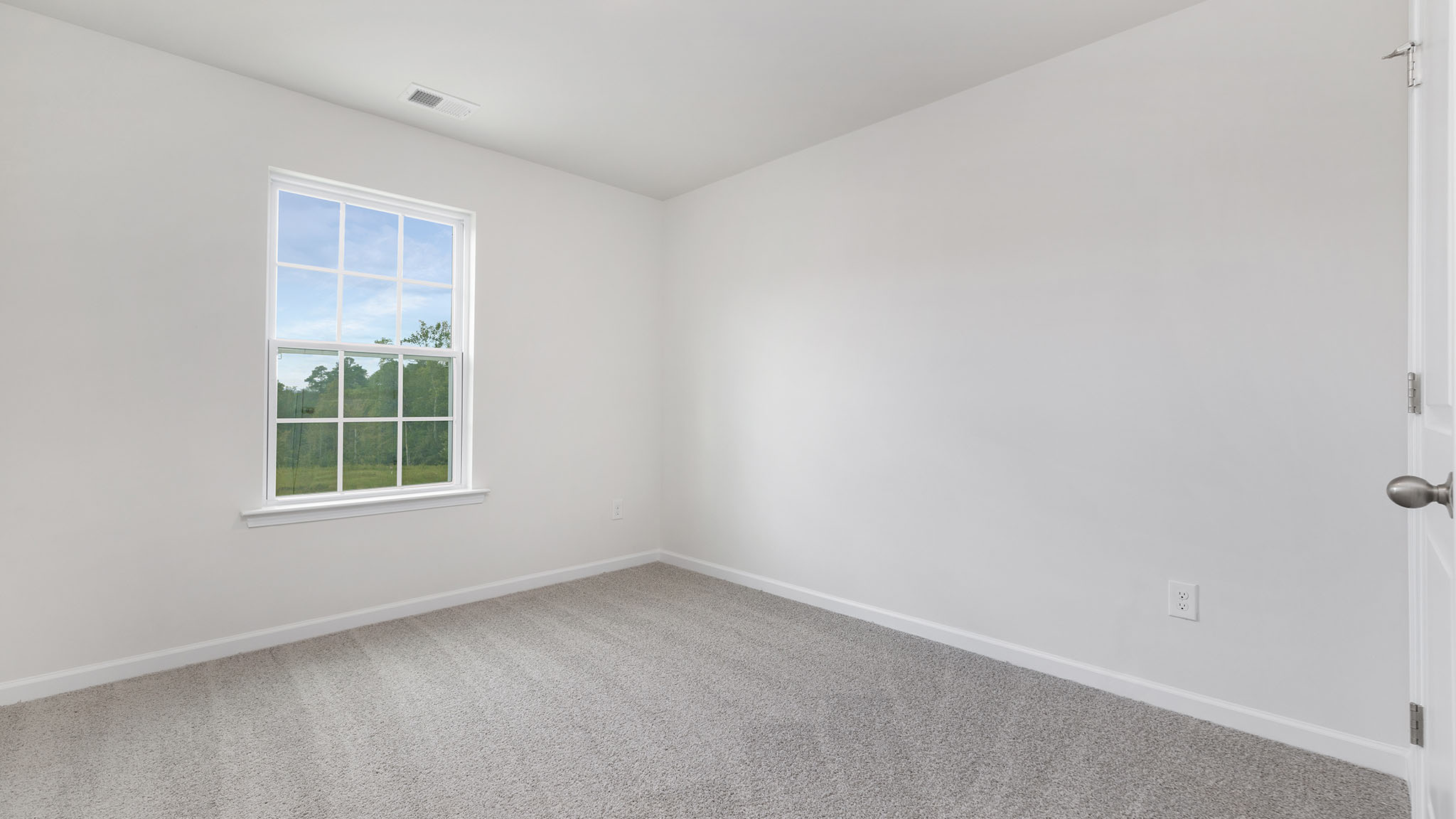 Carpeted bedroom with large windows