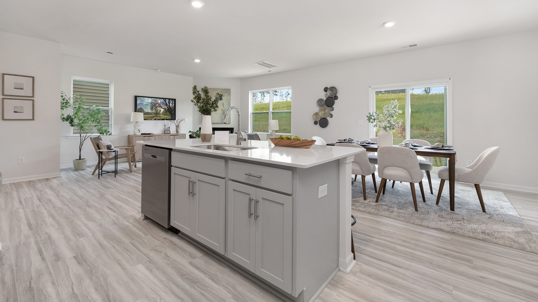 Kitchen and island, white cabinets, wood floors