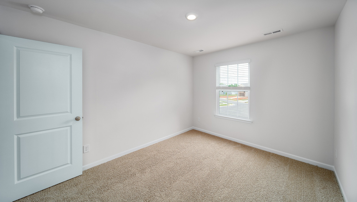 Carpeted bedroom with window