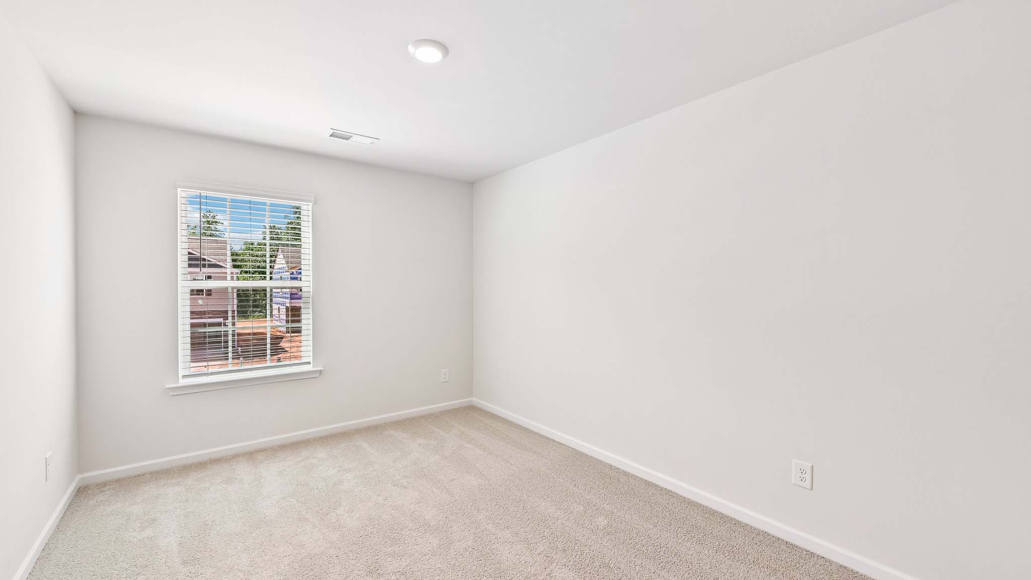 carpeted bedroom with large window