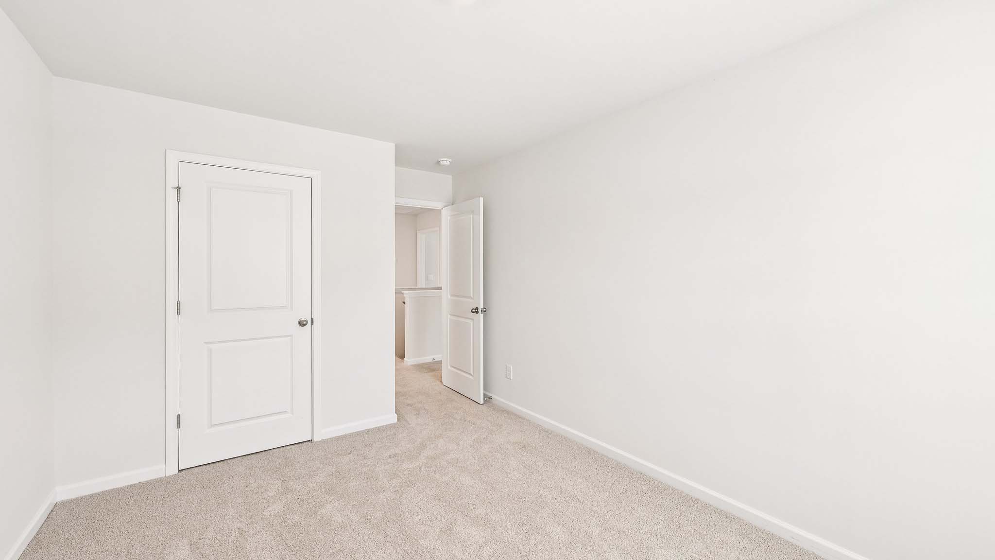 carpeted bedroom with large window