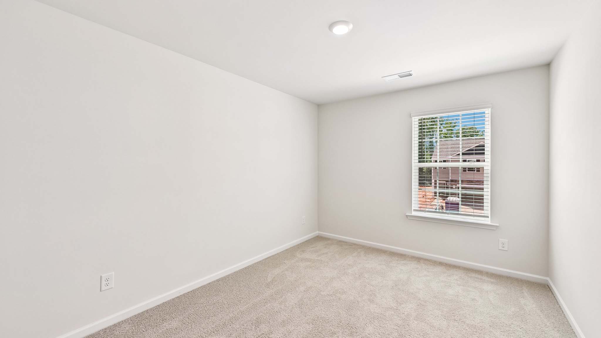 carpeted bedroom with large window