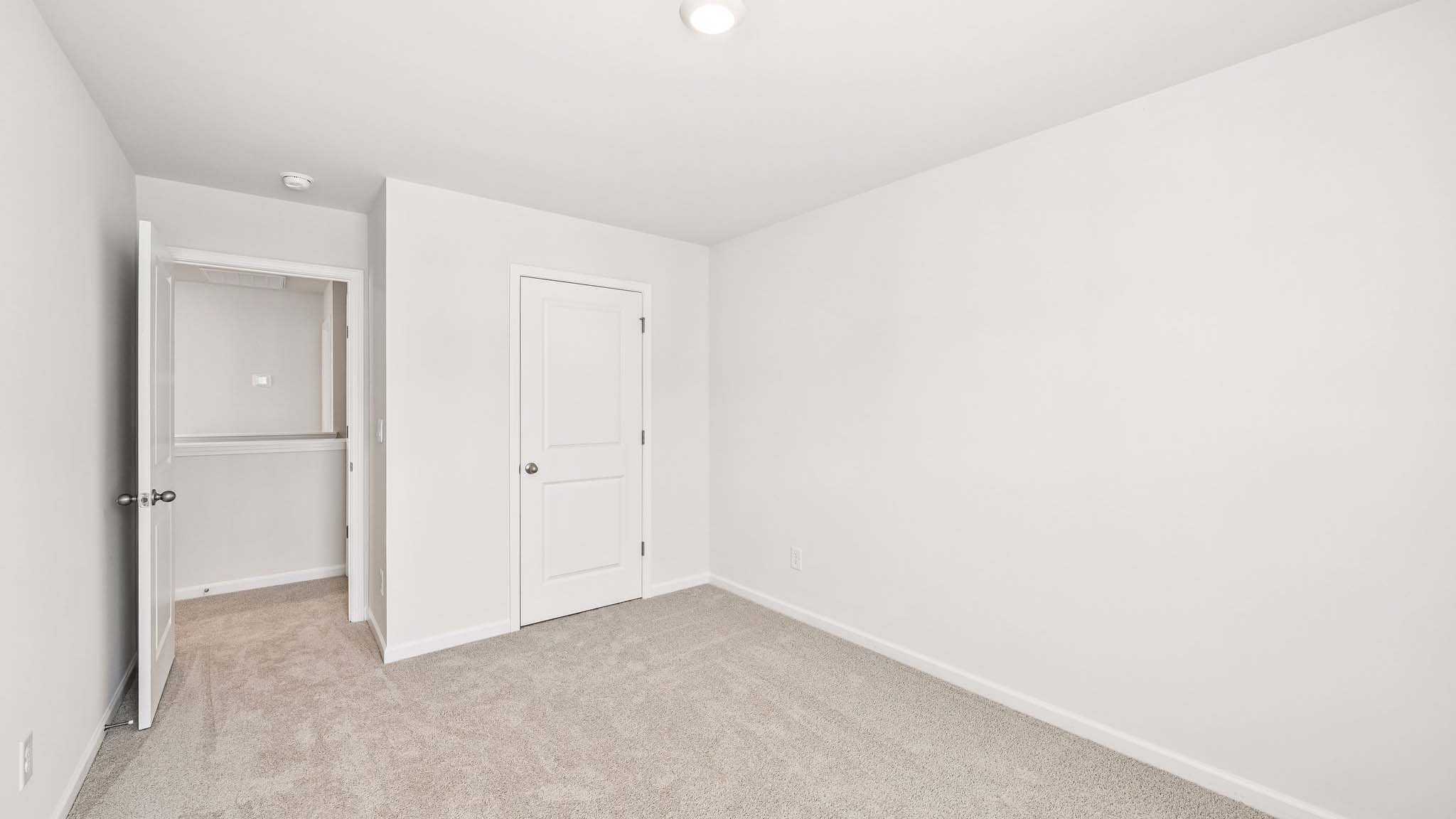 carpeted bedroom with large window