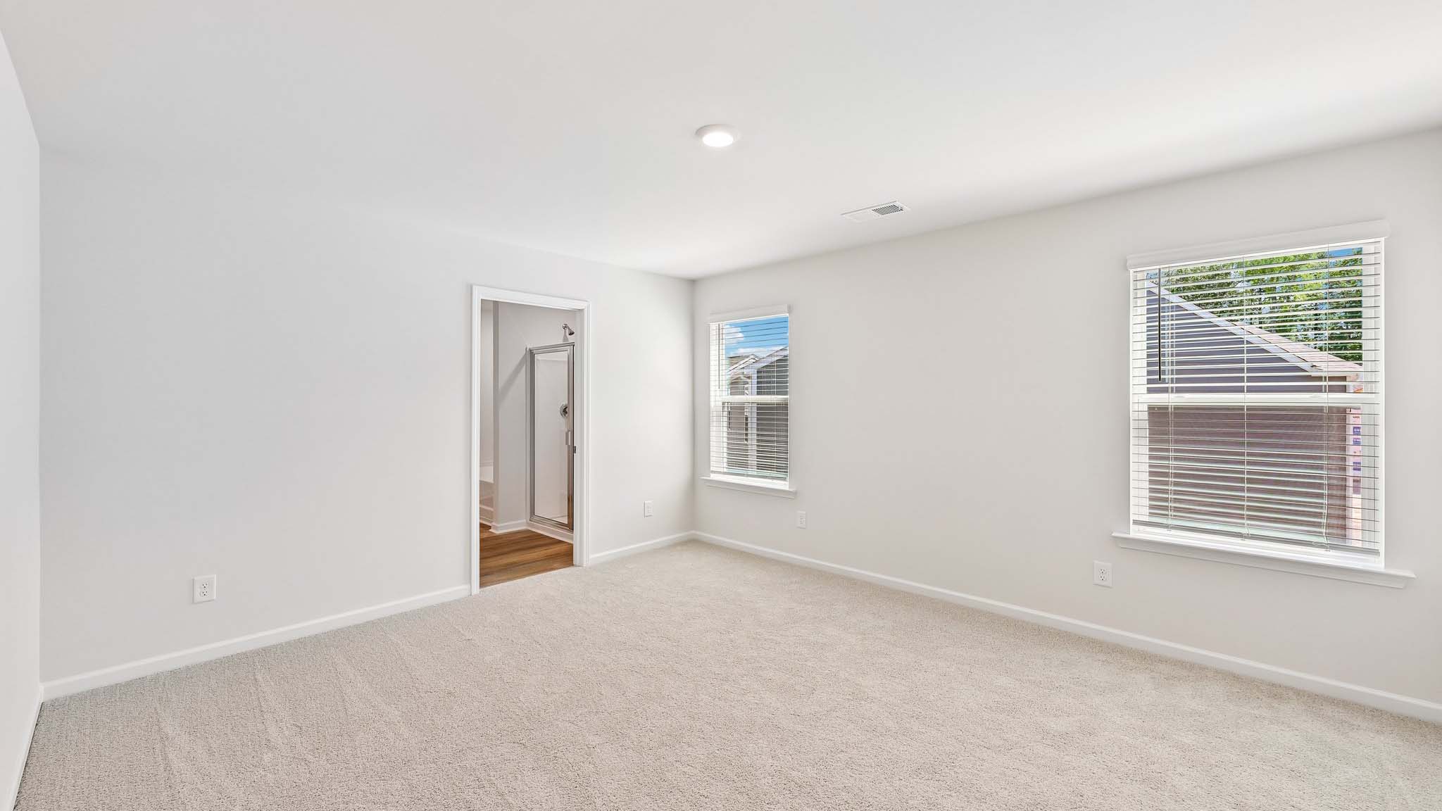 carpeted bedroom with large window
