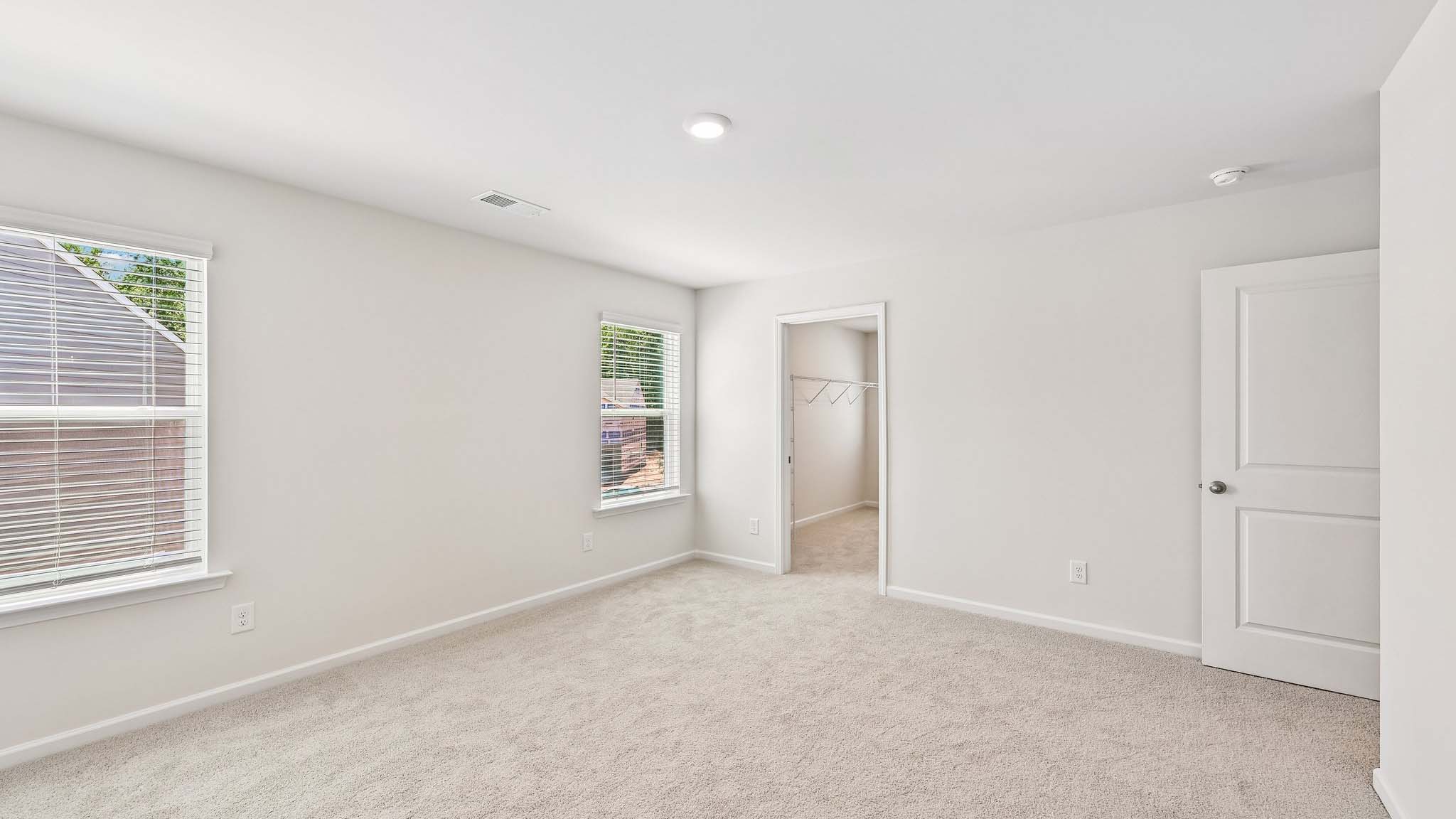carpeted bedroom with large window
