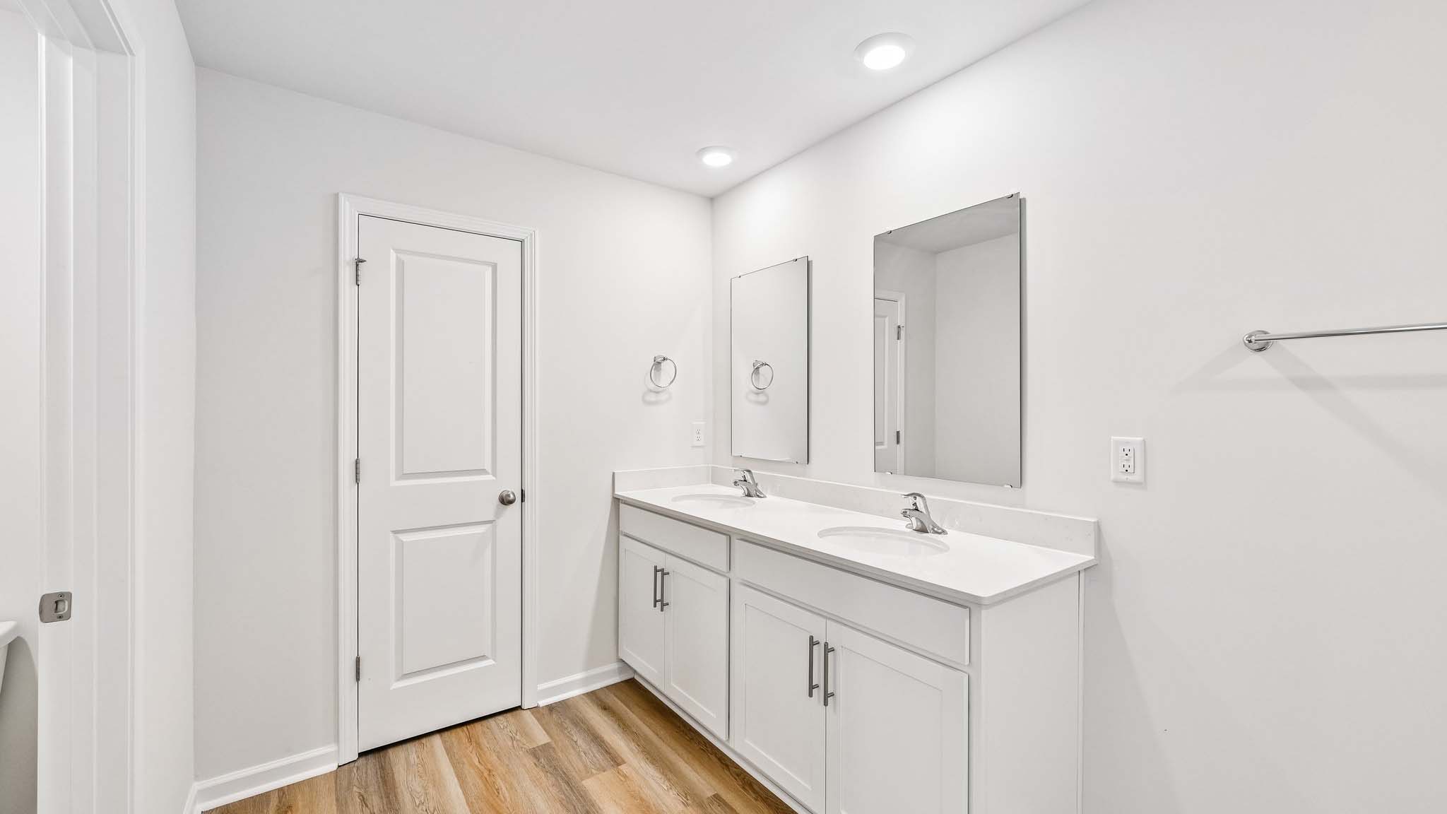 primary bathroom with dual vanity and walk in shower and soaking tub
