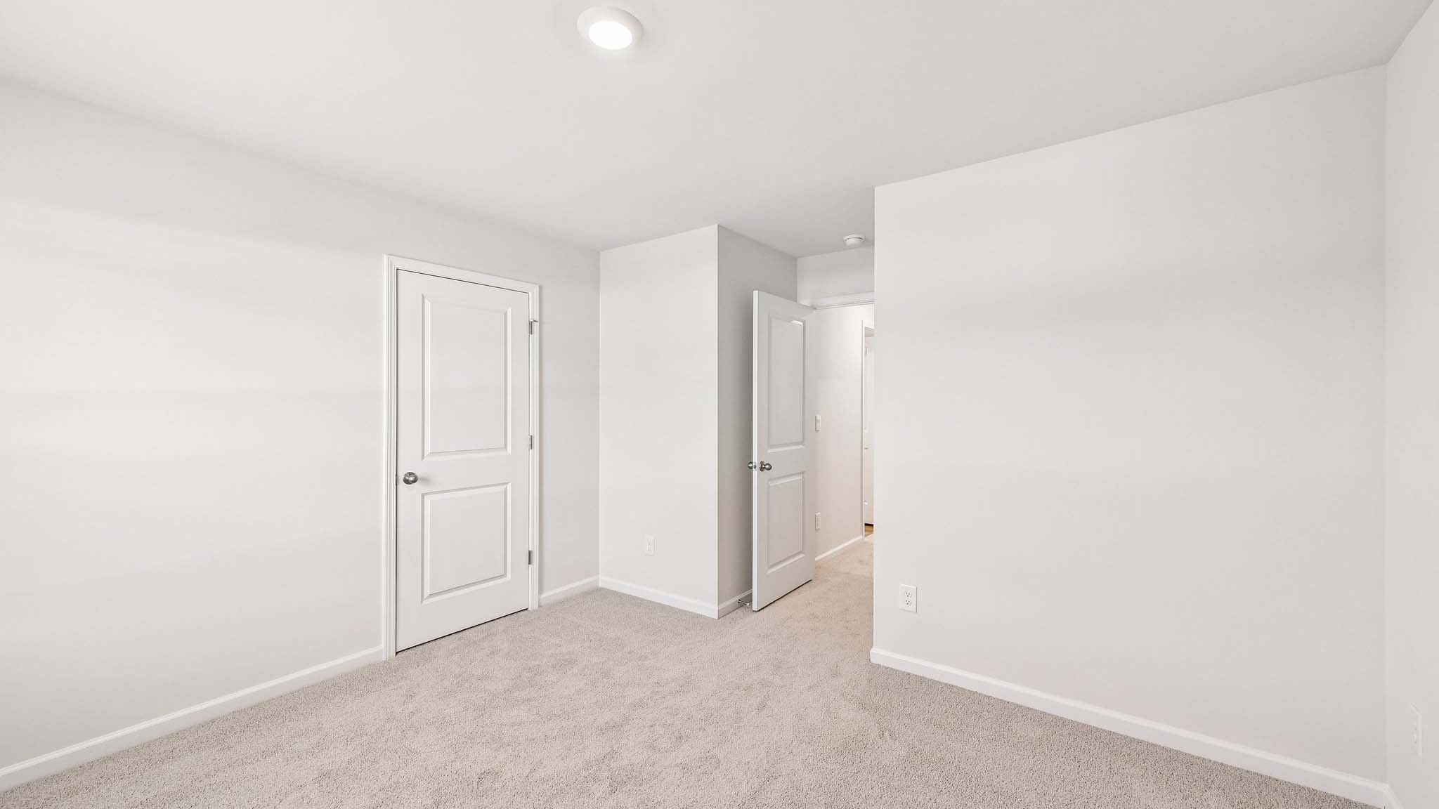 carpeted bedroom with large window