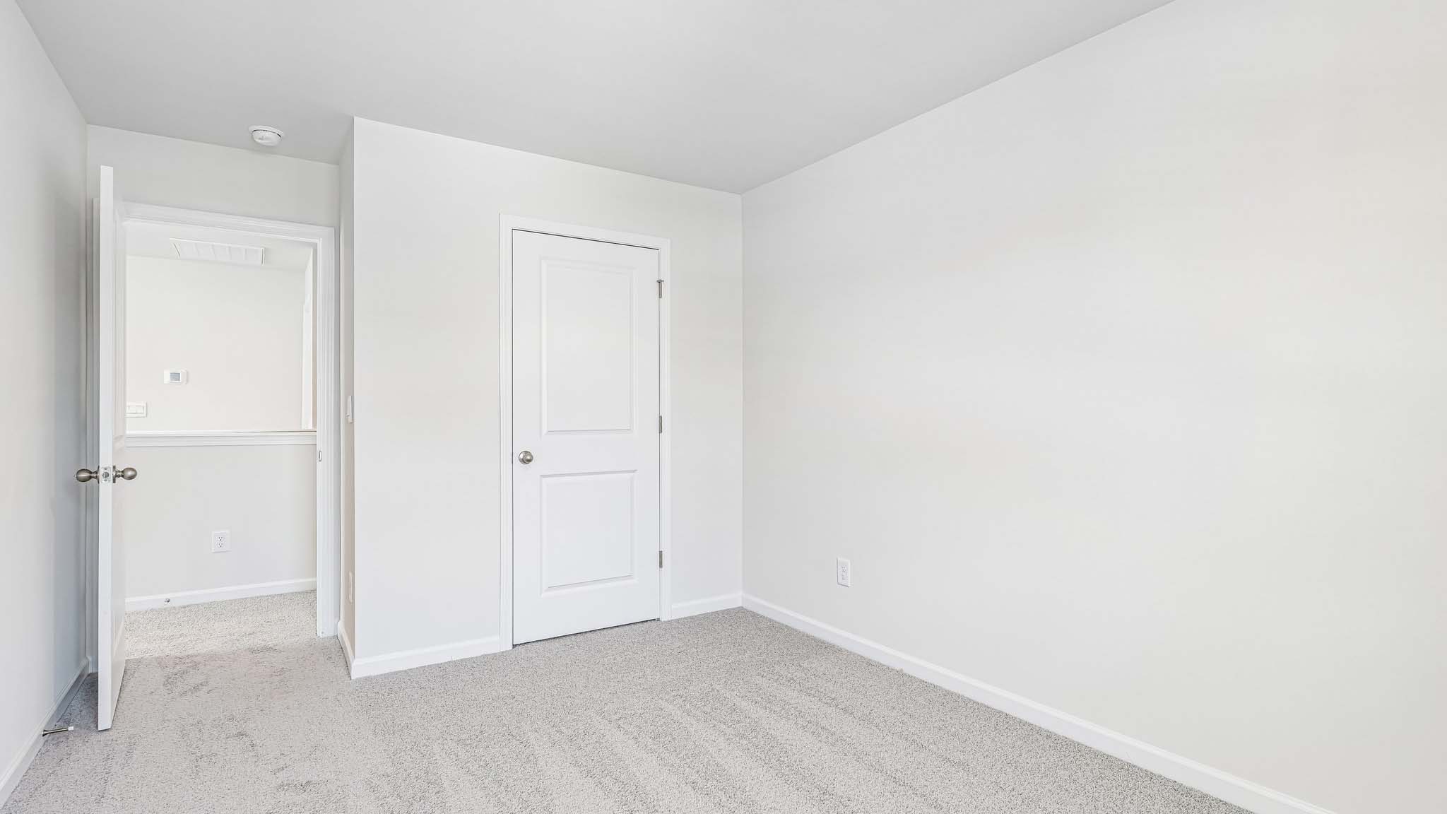 carpeted bedroom with large window