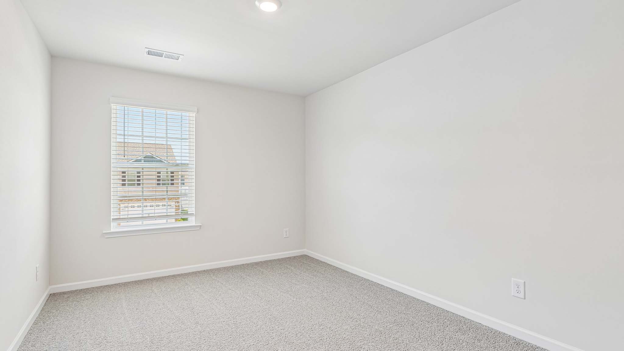 carpeted bedroom with large window