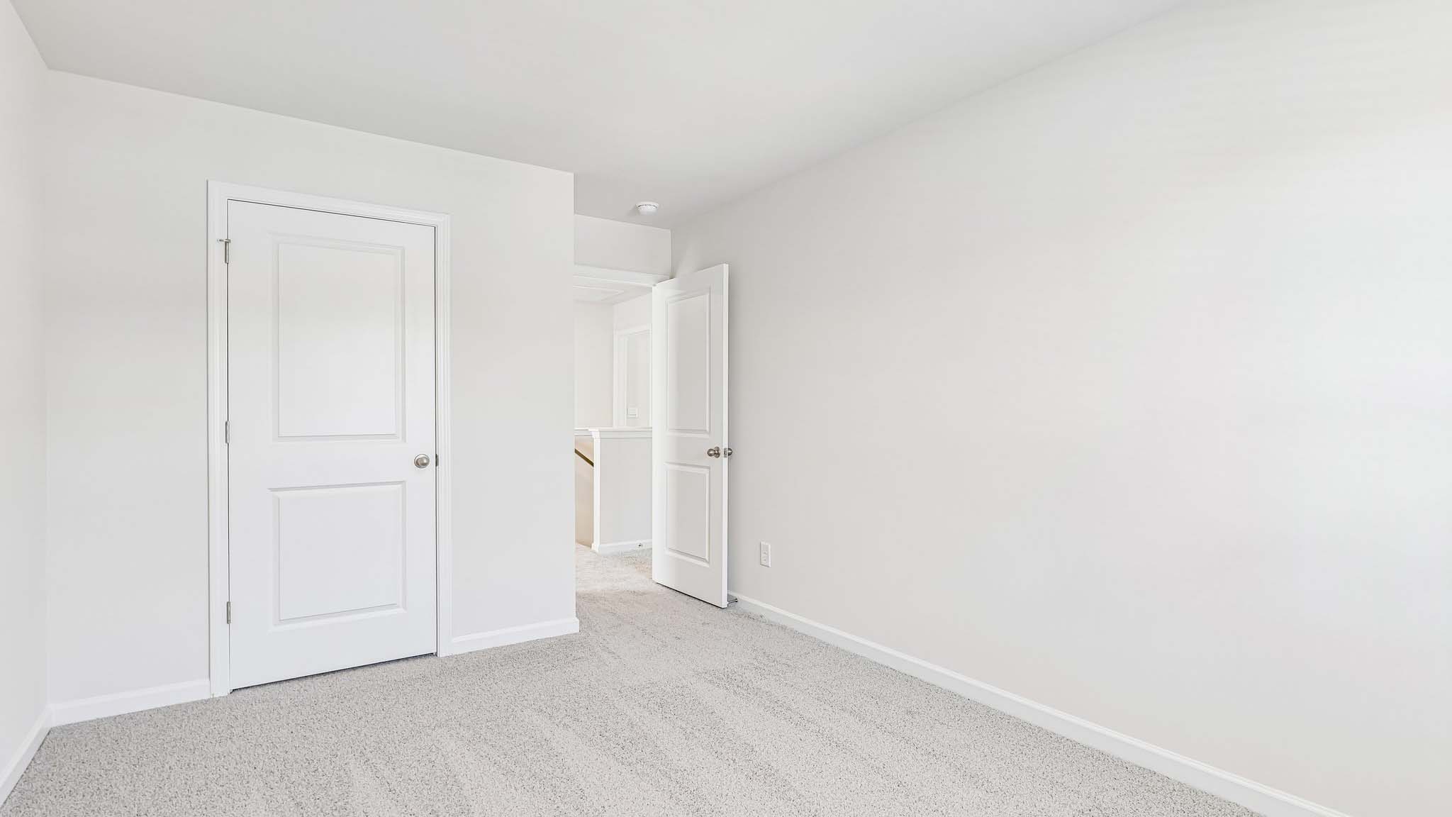 carpeted bedroom with large window
