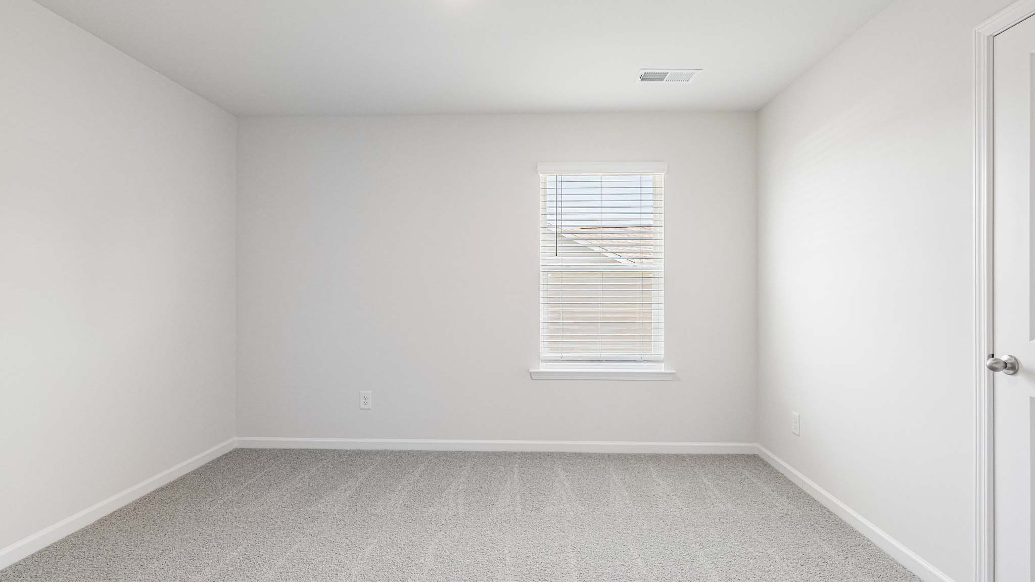 carpeted bedroom with large window
