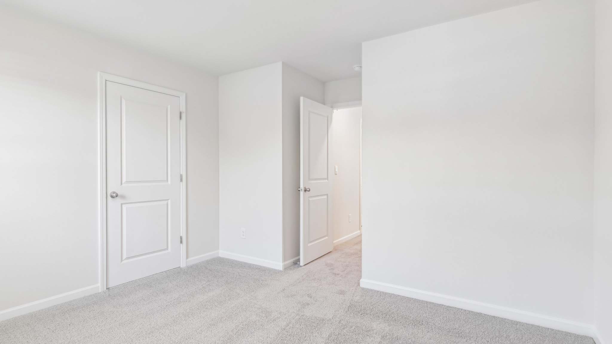 carpeted bedroom with large window