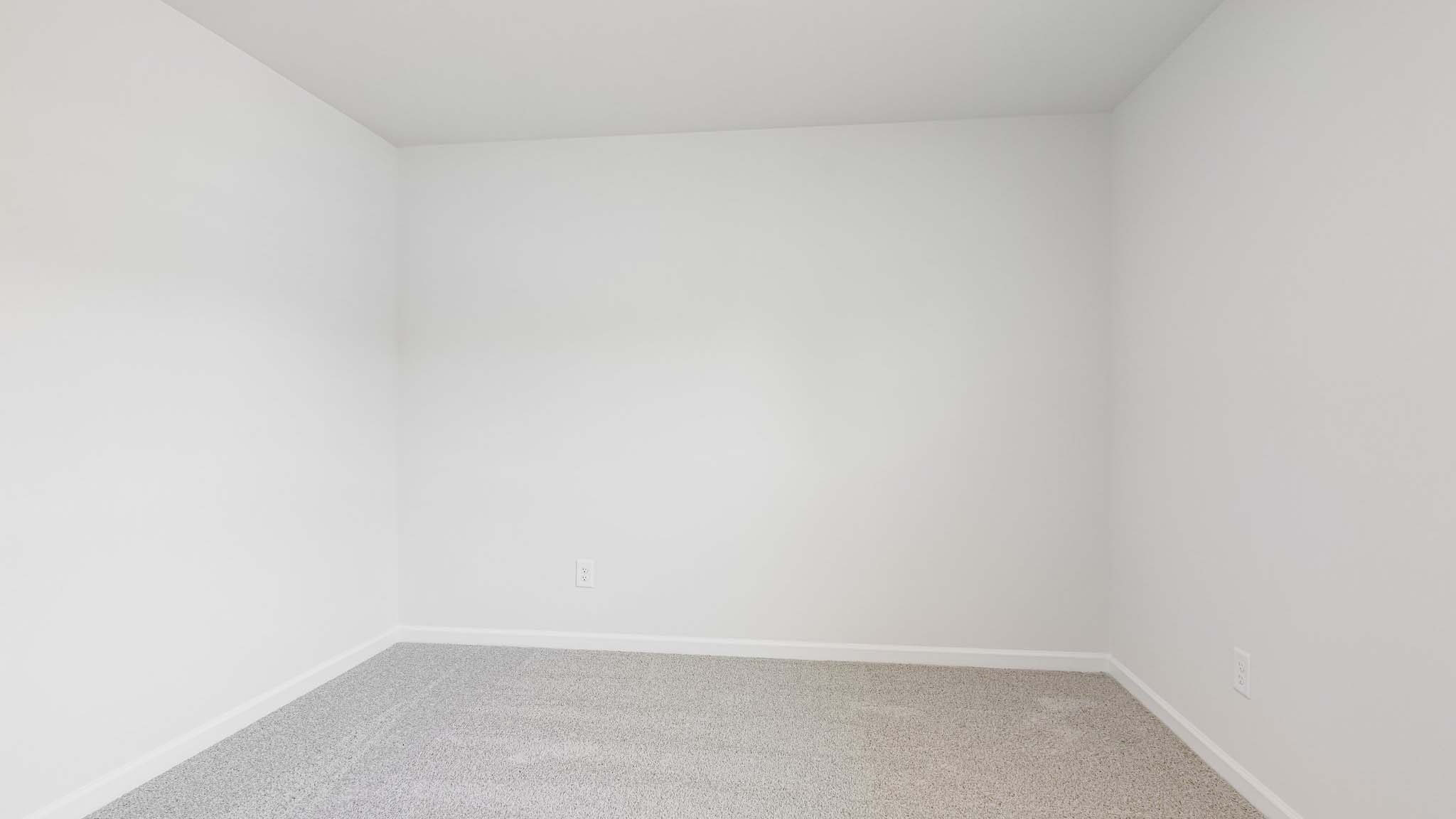 carpeted bedroom with large window