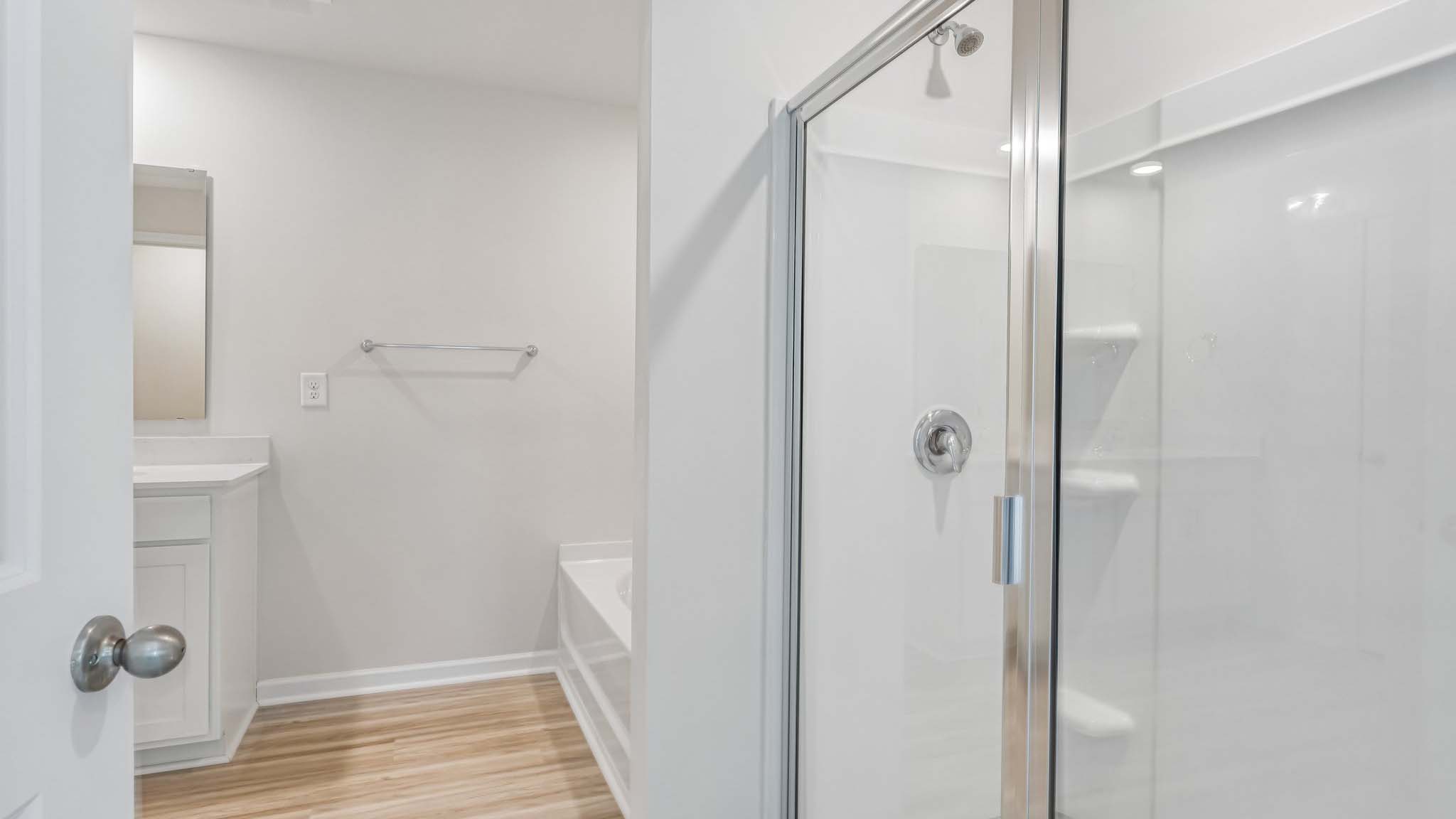 primary bathroom with dual vanity and walk in shower and soaking tub