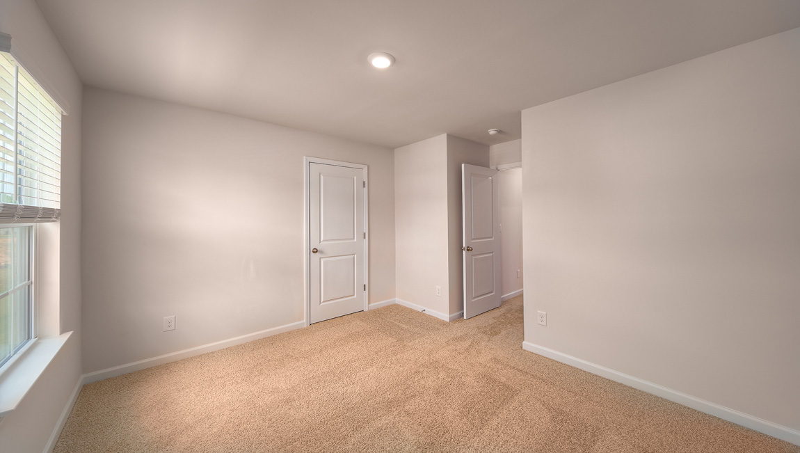 Carpeted bedroom with window