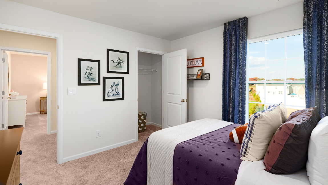 Carpeted bedroom with large window