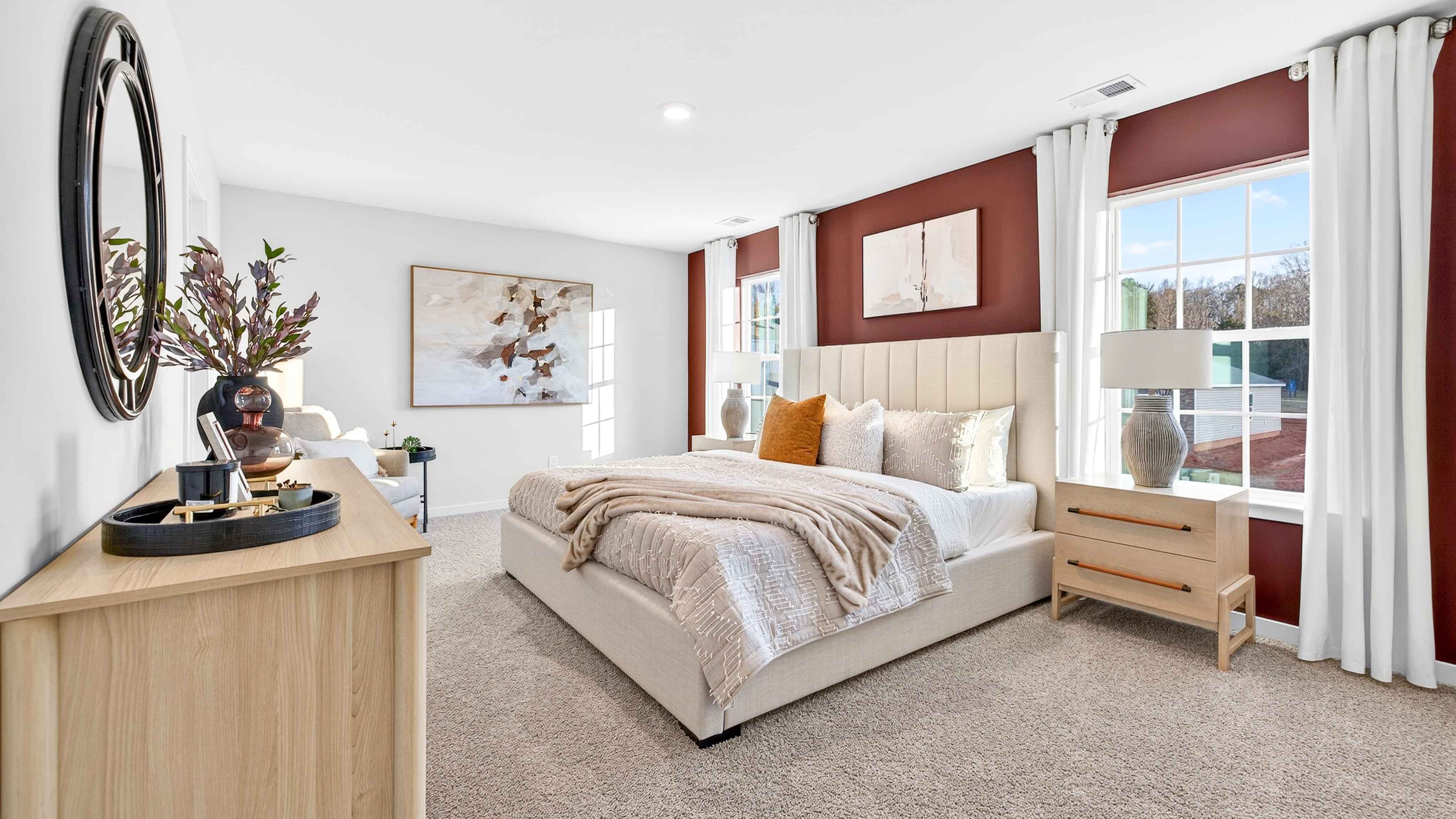 Primary bedroom, carpeted with two large windows